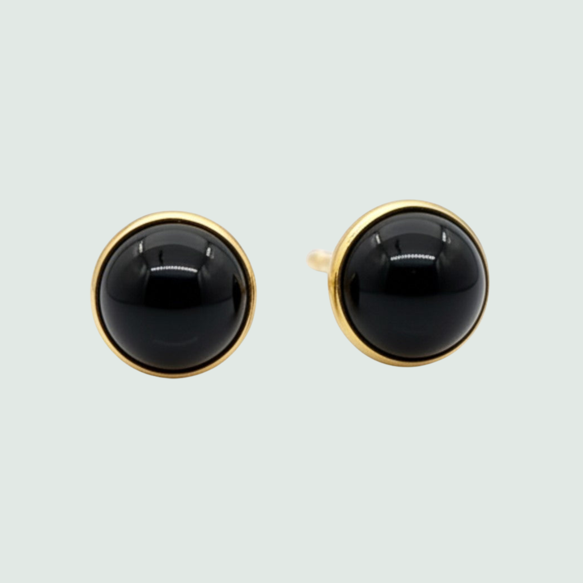 Black Onyx Round Mini Stud Earrings in Solid 14K Gold, shown on a sage mist background