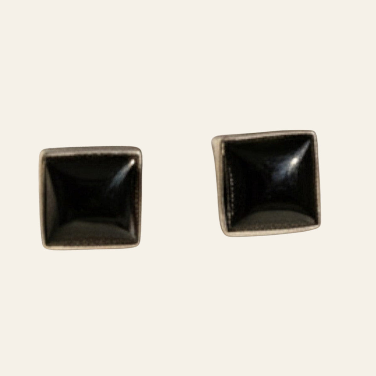 Black Onyx Square Stud Earrings in Sterling Silver, shown on a cream background