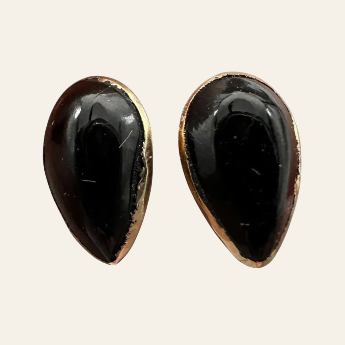 Black Onyx Teardrop Stud Earrings in Solid 14K Gold, shown on a cream background