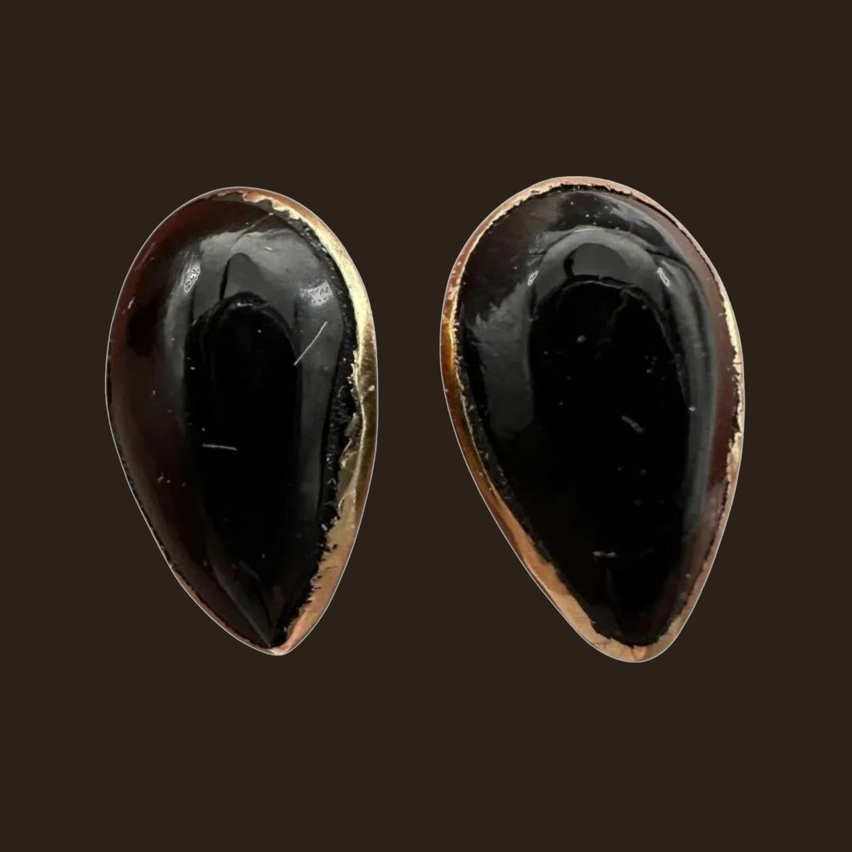 Black Onyx Teardrop Stud Earrings in Solid 14K Gold, shown on an espresso background