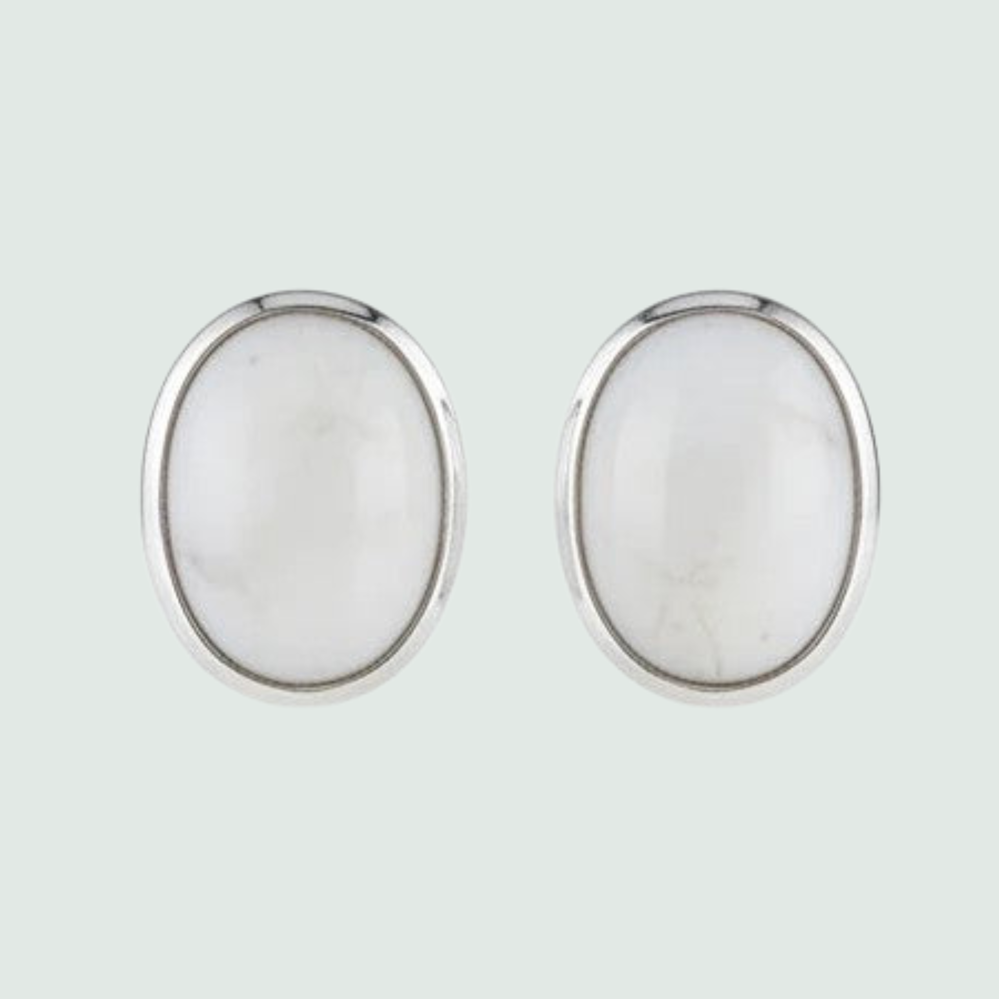 Cream Mother of Pearl Oval Stud Earrings in Sterling Silver, shown on a sage mist background