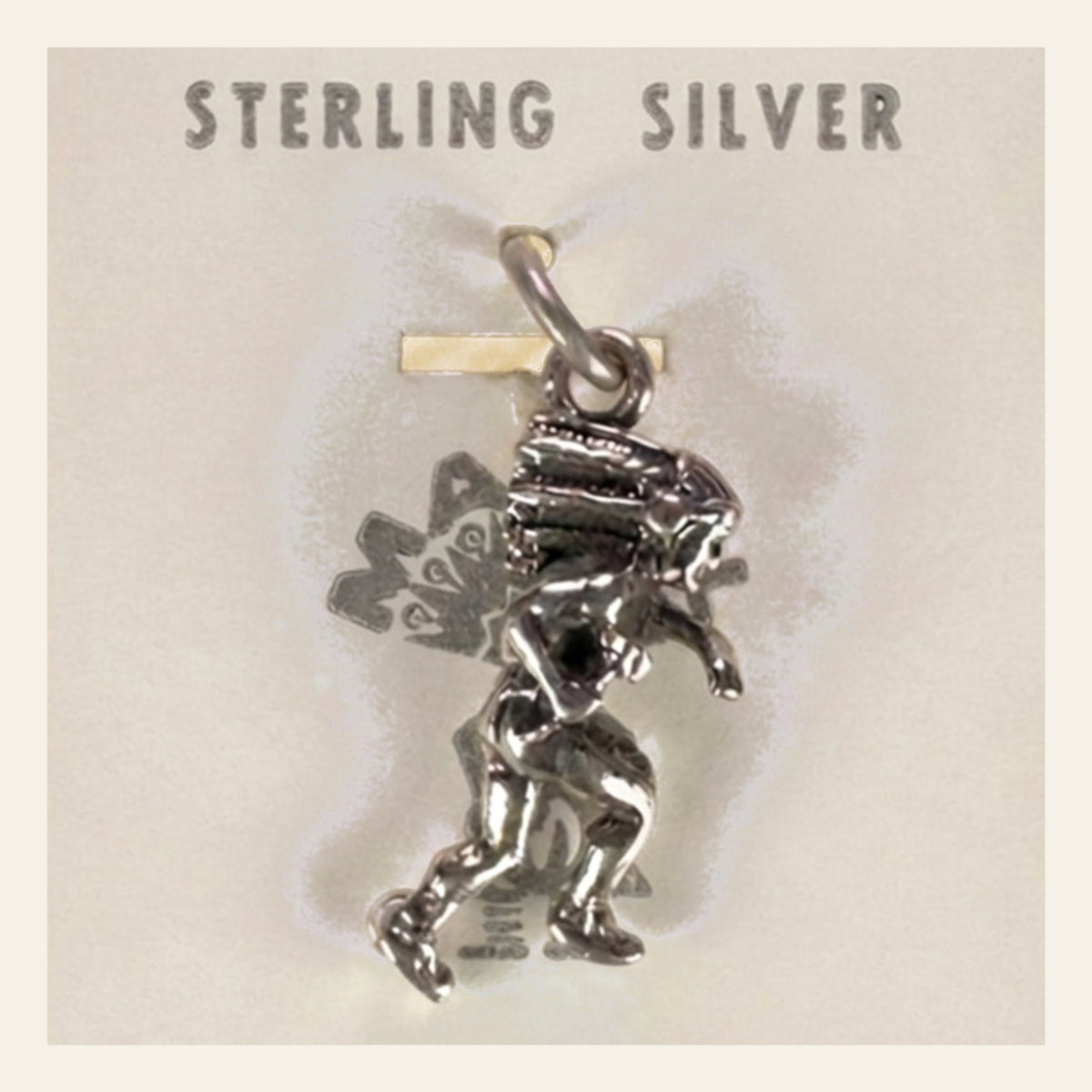 Dancer in Headdress Charm in Sterling Silver, Vintage Maisel's New Old Stock, shown on a cream background
