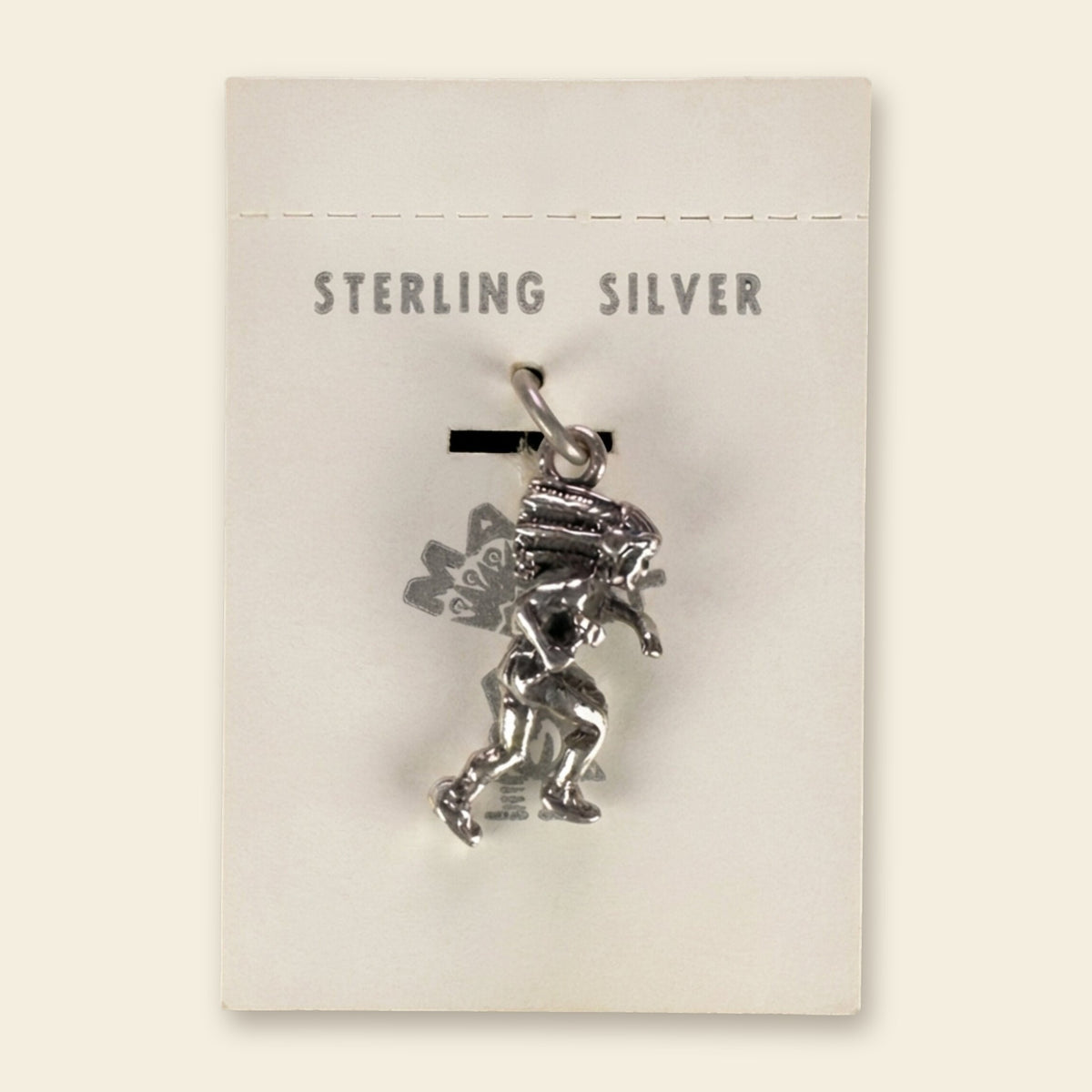 Dancer in Headdress Charm in Sterling Silver, Vintage Maisel's New Old Stock, shown on an ivory background