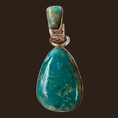 Fox Turquoise Teardrop Pendant in Sterling Silver, by Martinez, shown on an espresso background