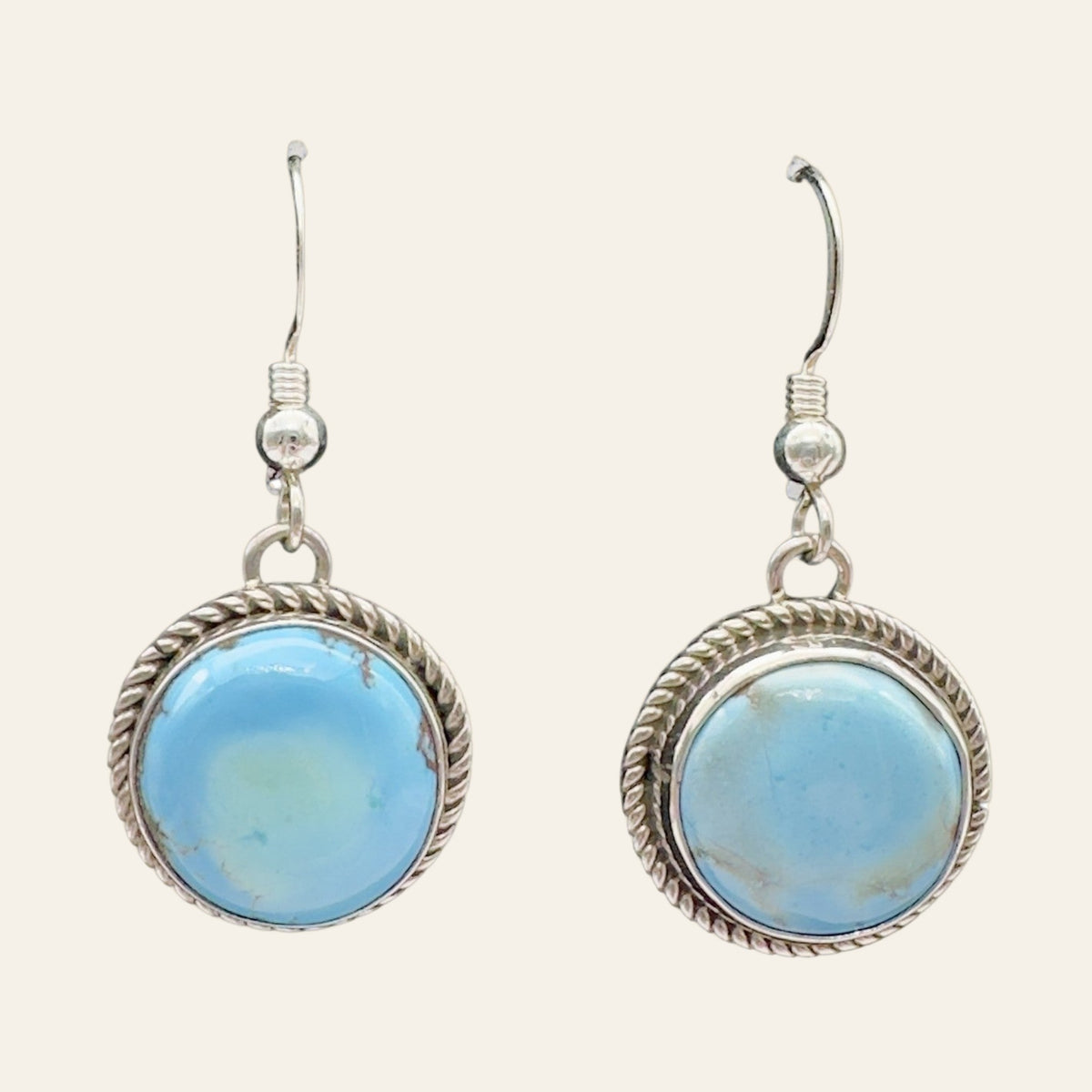Golden Hills Turquoise Earrings in Sterling Silver, shown on a cream background
