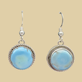 Golden Hills Turquoise Earrings in Sterling Silver, shown on a desert plaster background