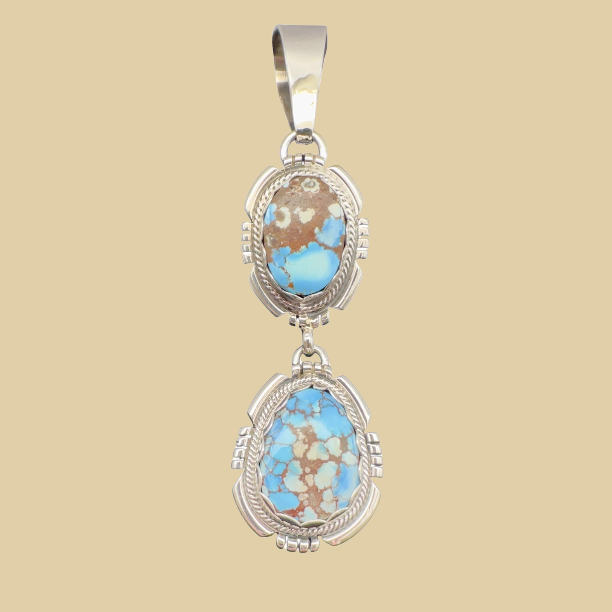 Golden Hills Turquoise Pendant Necklace in Navajo Sterling Silver, by Randy Billy, shown on a desert plaster background