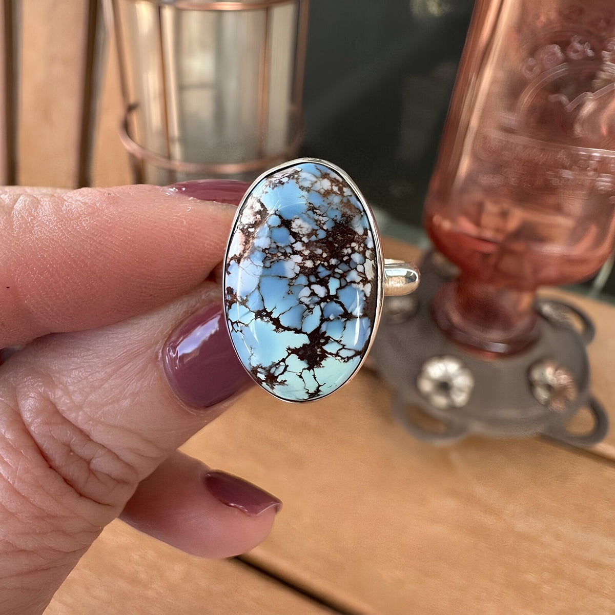 Golden Hills turquoise sterling silver ring held in hand, showing the scale of the 10 carat oval stone