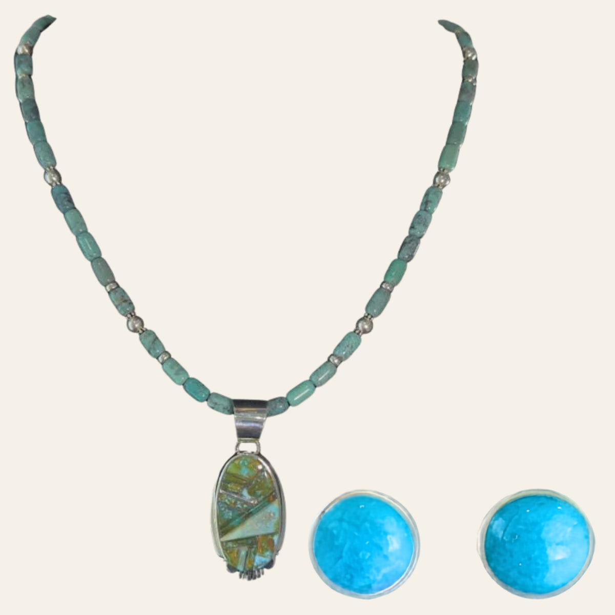 Green Turquoise Pendant and Turquoise Stud Earrings Set in Sterling Silver, shown on a cream background