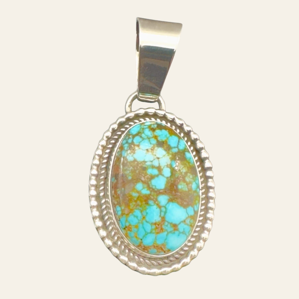 Kingman Red Web Turquoise Oval Pendant in Navajo Sterling Silver, by Mary Ellen, shown on a cream background