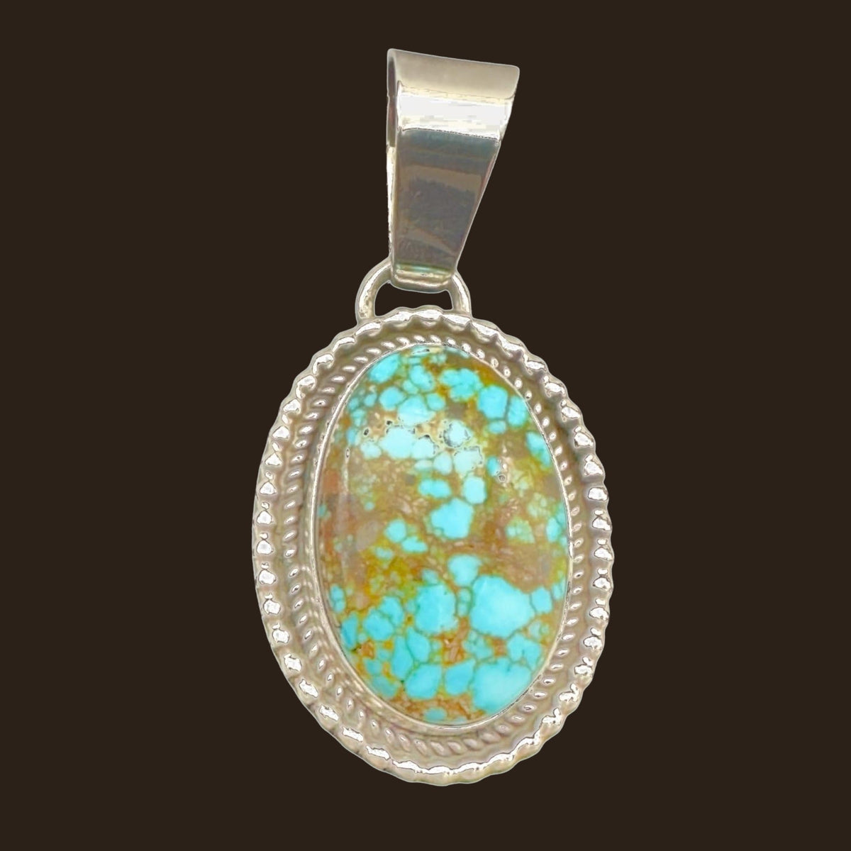 Kingman Red Web Turquoise Oval Pendant in Navajo Sterling Silver, by Mary Ellen, shown on an espresso background