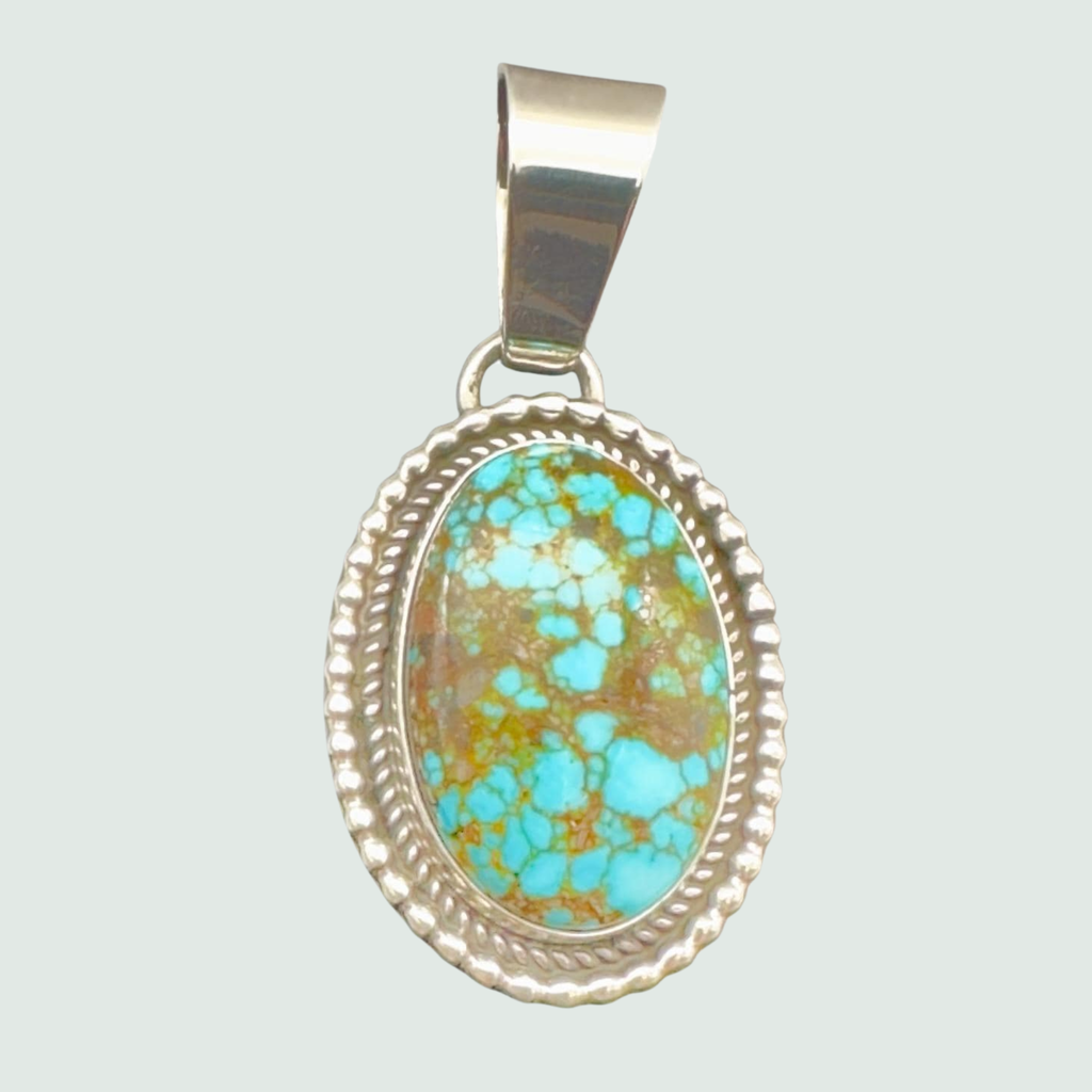 Kingman Red Web Turquoise Oval Pendant in Navajo Sterling Silver, shown on a sage mist background