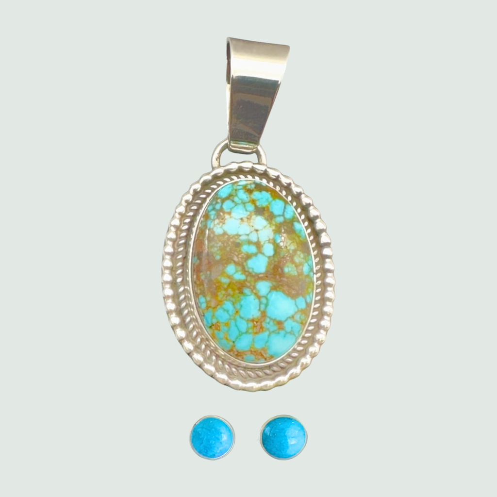 Kingman Red Web turquoise pendant and turquoise stud earrings jewelry set in sterling silver, shown on a sage mist background