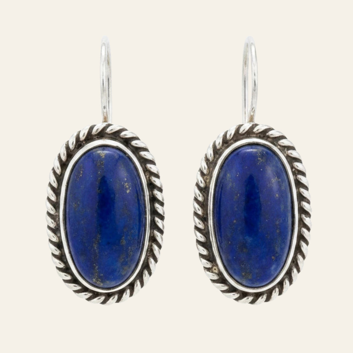 Lapis Lazuli Earrings, Oval Drops in Sterling Silver with Twisted Rope Border, shown on a cream background