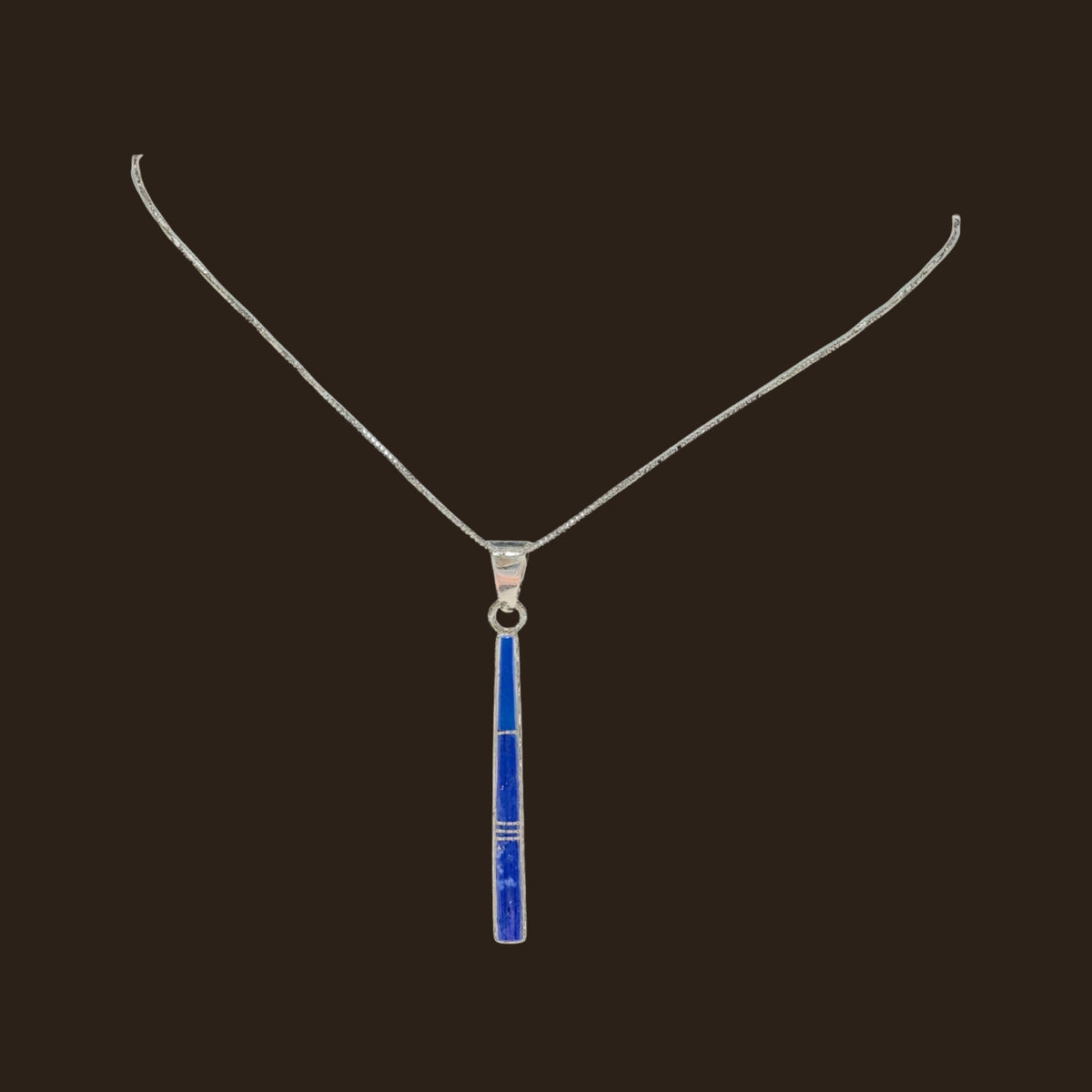 Lapis Lazuli Necklace in Sterling Silver, by Rick Tolino, shown on an espresso background