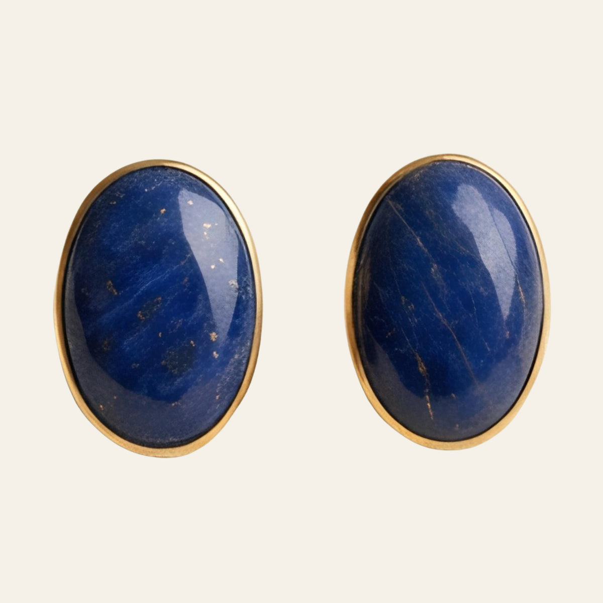 Lapis Lazuli Oval Stud Earrings in Solid 14K Gold, shown on a cream background