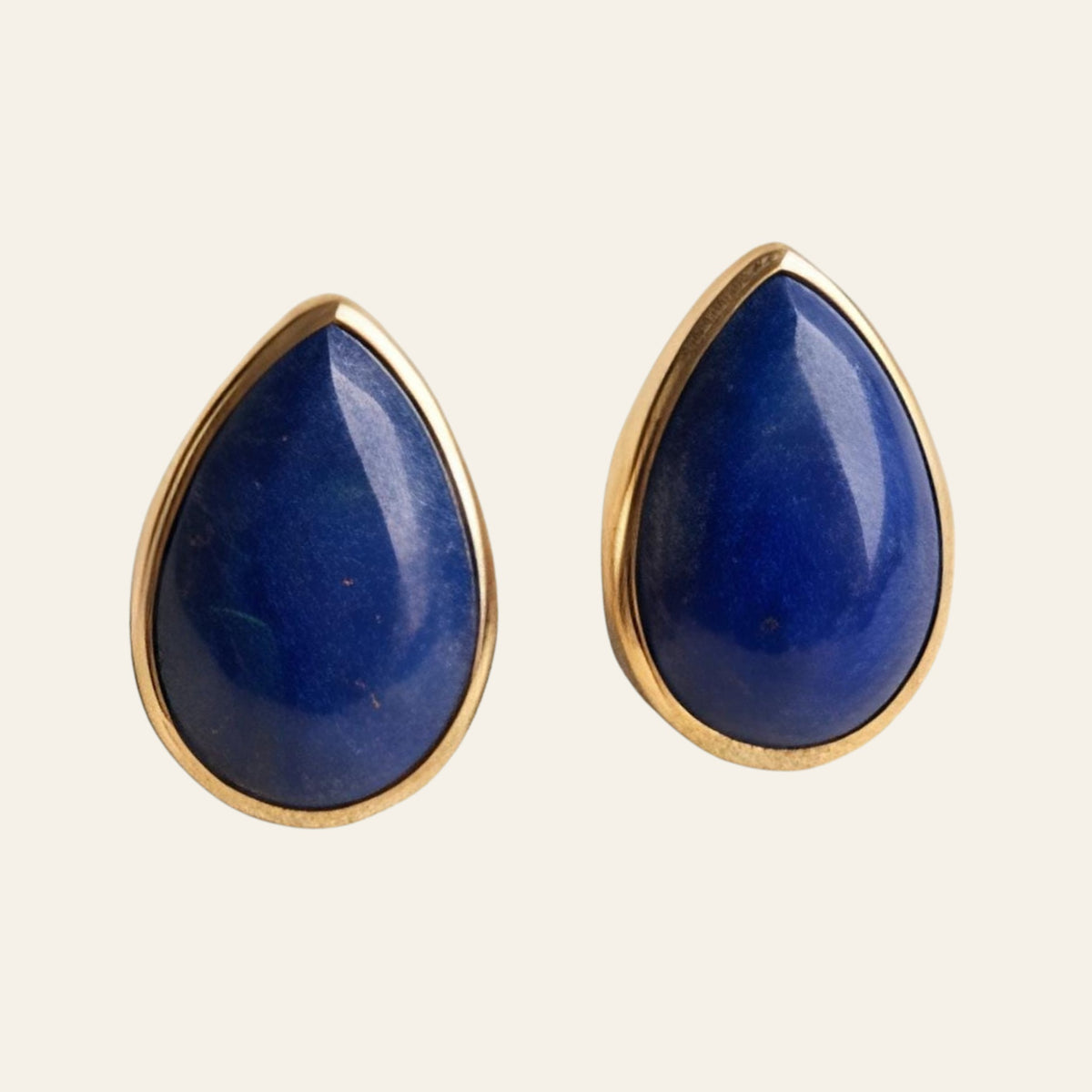 Lapis Lazuli Teardrop Stud Earrings in Solid 14K Gold, shown on a cream background