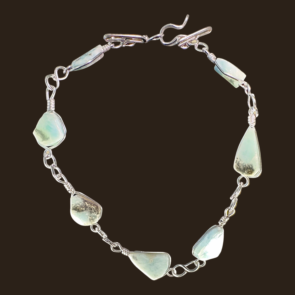 Larimar Adjustable Anklet and Bracelet in Sterling Silver, shown on an espresso background