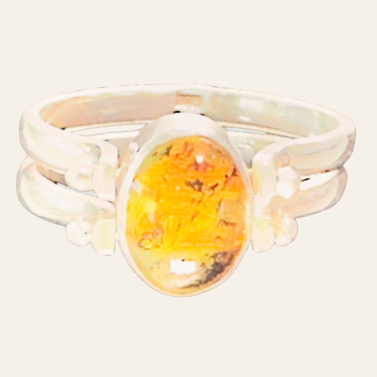 Larimar and Amber Reversible Flip Ring in Sterling Silver, shown on a cream background