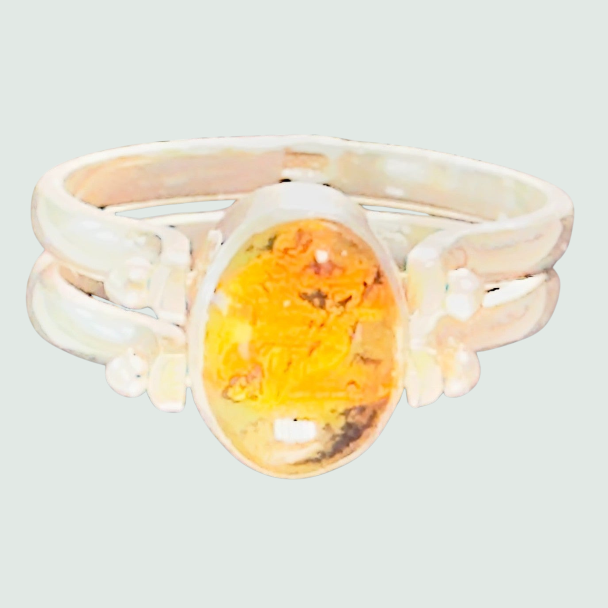 Larimar and Amber Reversible Flip Ring in Sterling Silver, shown on a sage mist background