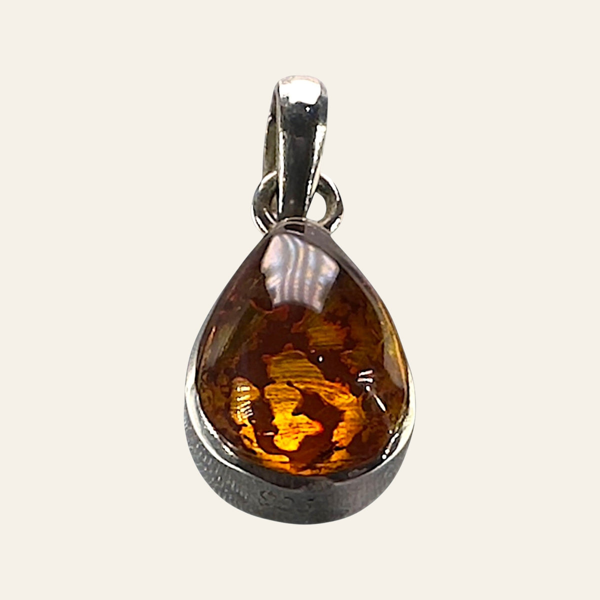 Larimar and Amber Reversible Teardrop Pendant in Sterling Silver, shown on a cream background