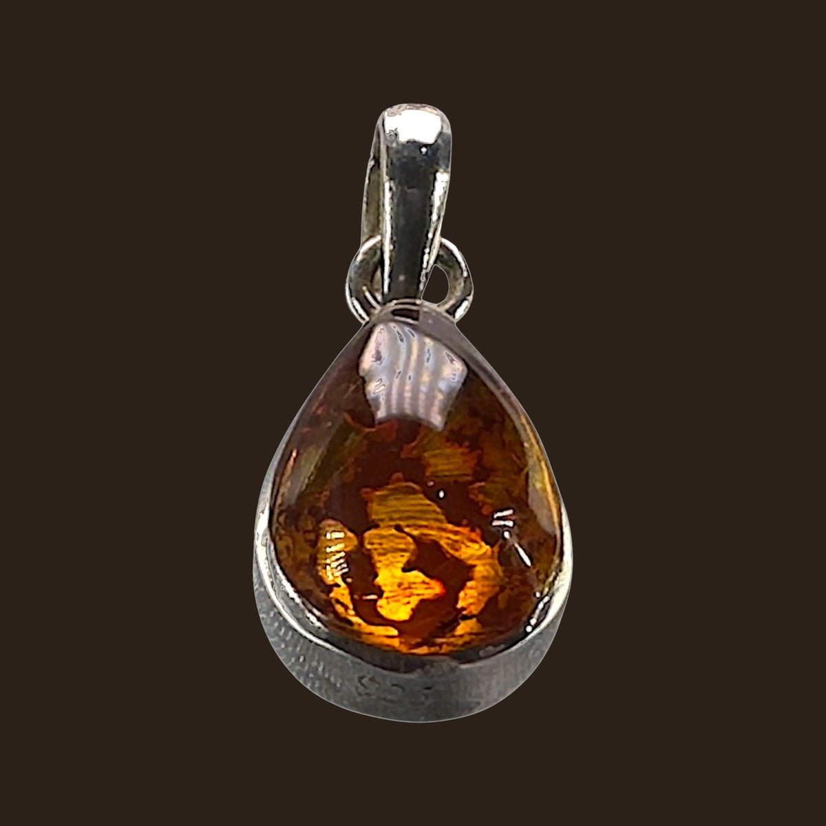 Larimar and Amber Reversible Teardrop Pendant in Sterling Silver, shown on an espresso background