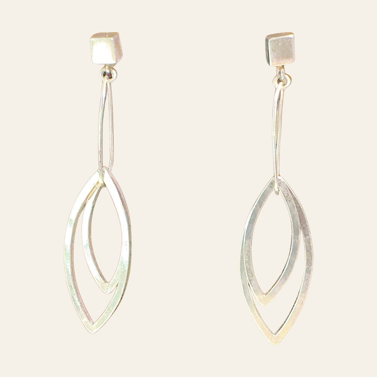 Leaf Dangle Earrings in Sterling Silver, by Grace Chin, shown on a cream background