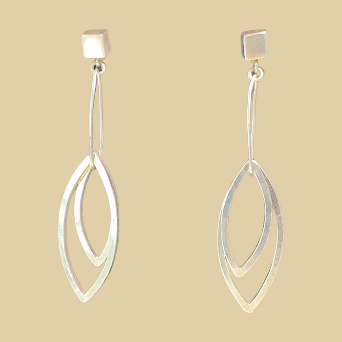 Leaf Dangle Earrings in Sterling Silver, by Grace Chin, shown on a desert plaster background