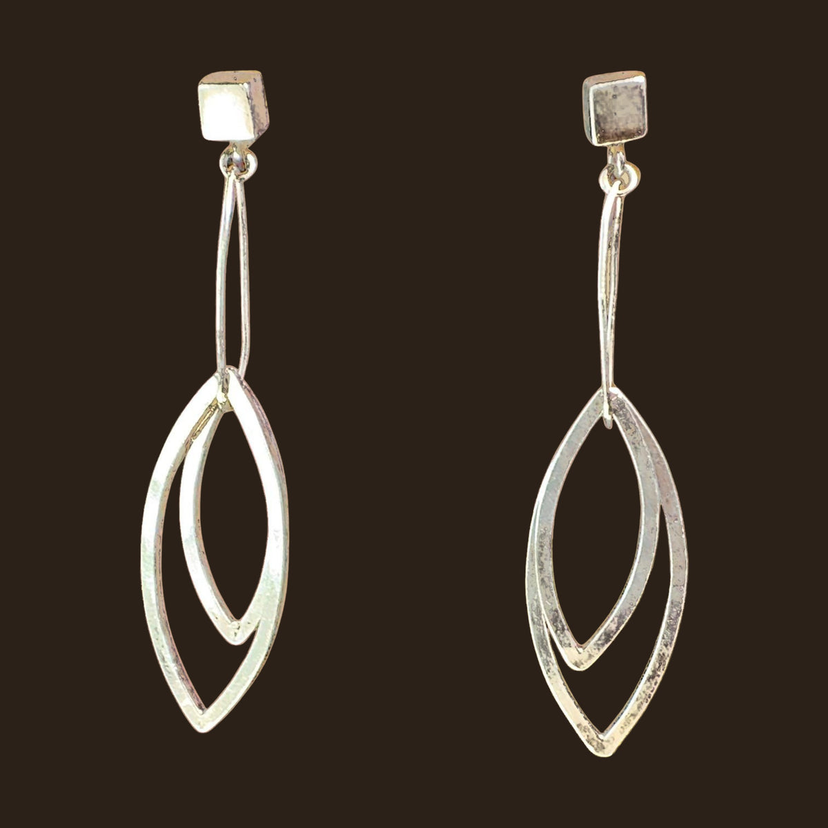 Leaf Dangle Earrings in Sterling Silver, by Grace Chin, shown on an espresso background
