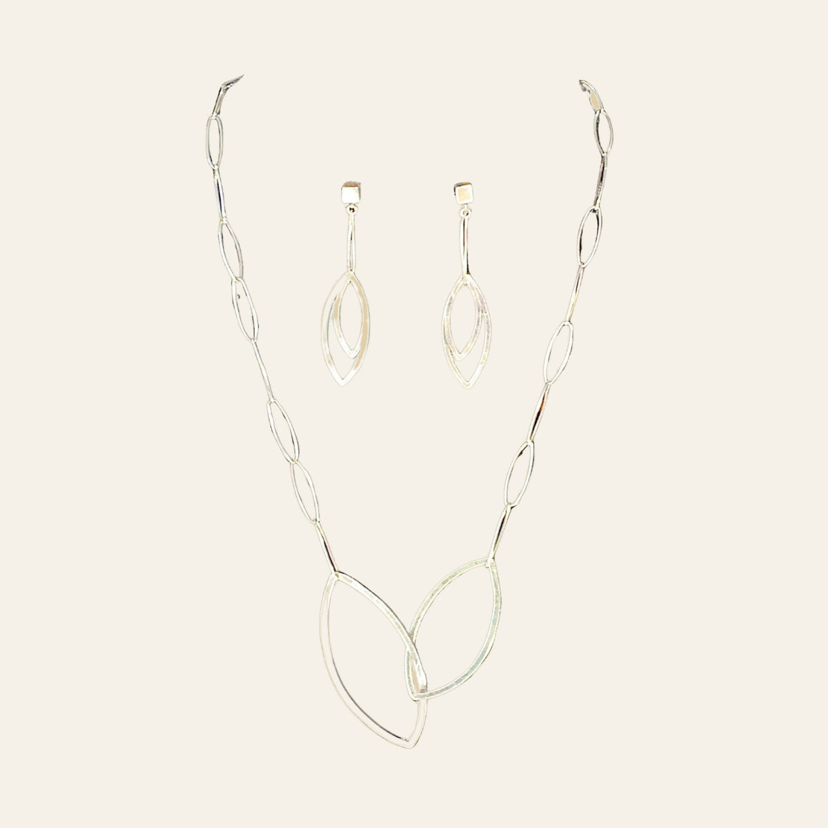 Leaf Necklace and Earrings in Sterling Silver, by Grace Chin (SET), shown on a cream background