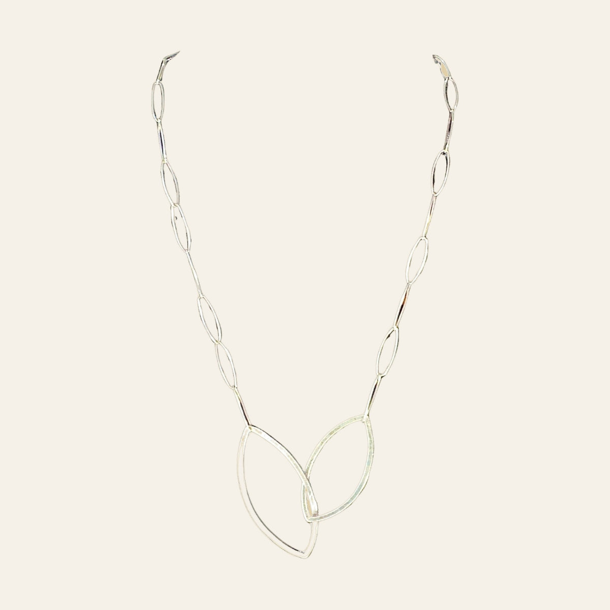 Leaf Pendant Necklace in Sterling Silver, by Grace Chin, shown on a cream background