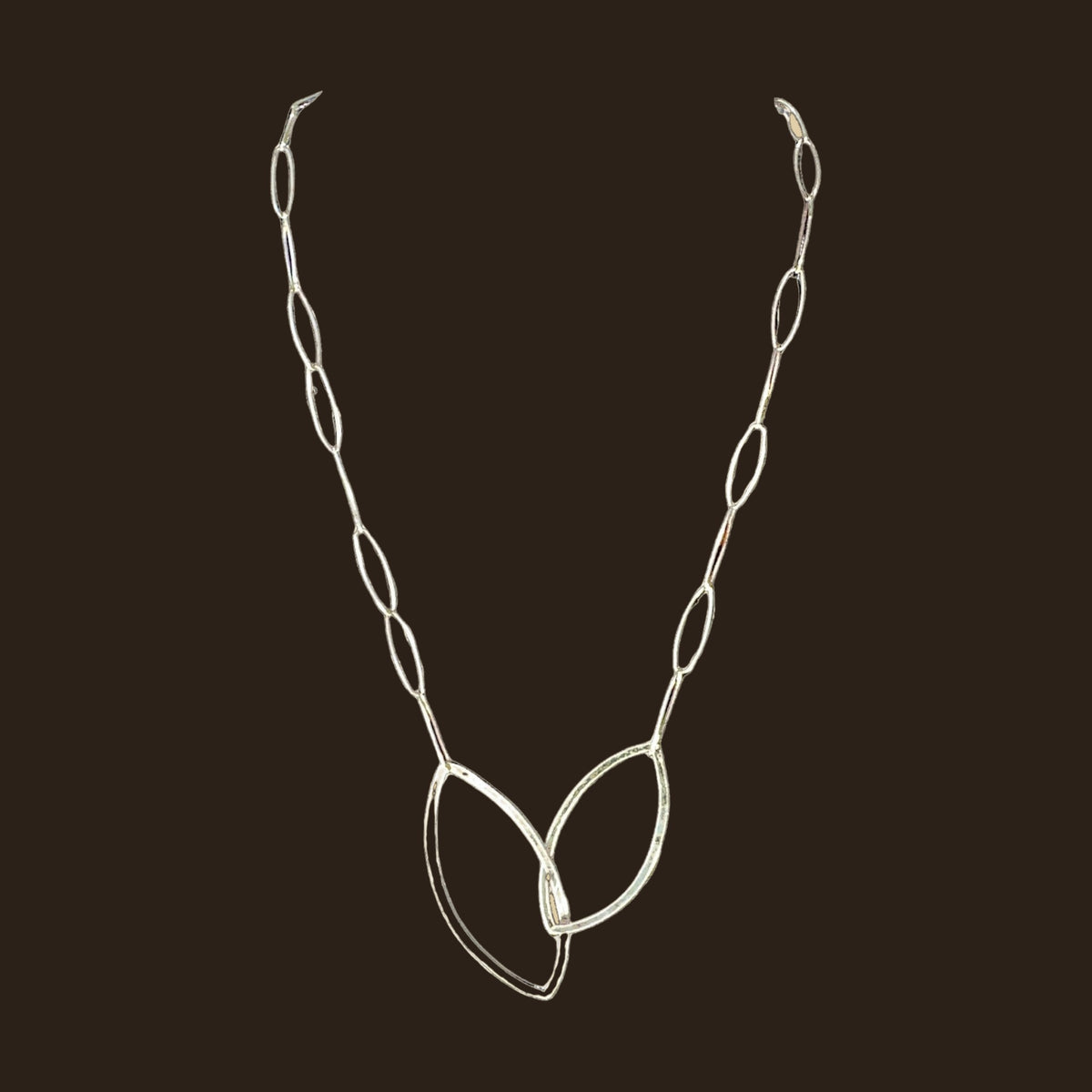 Leaf Pendant Necklace in Sterling Silver, by Grace Chin, shown on an espresso background