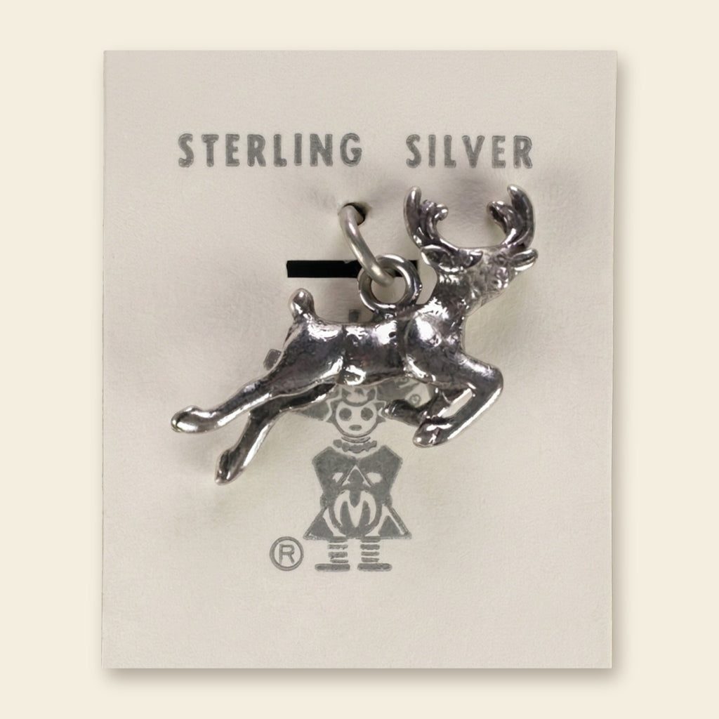Leaping Elk Charm in Sterling Silver, Vintage Maisel's New Old Stock, shown on an ivory background
