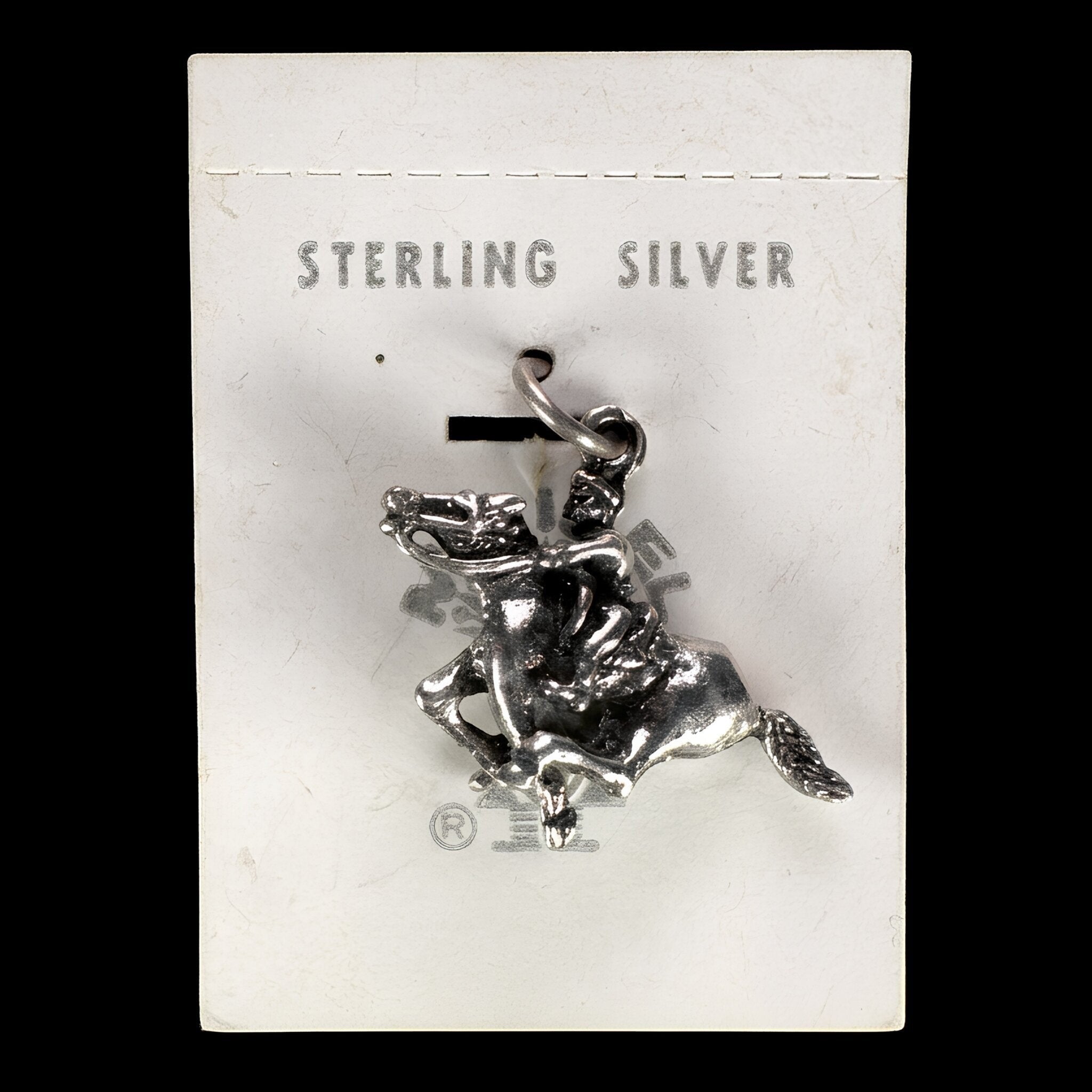 Vintage Maisel's sterling silver bucking bronco charm with rider on its original trading post card