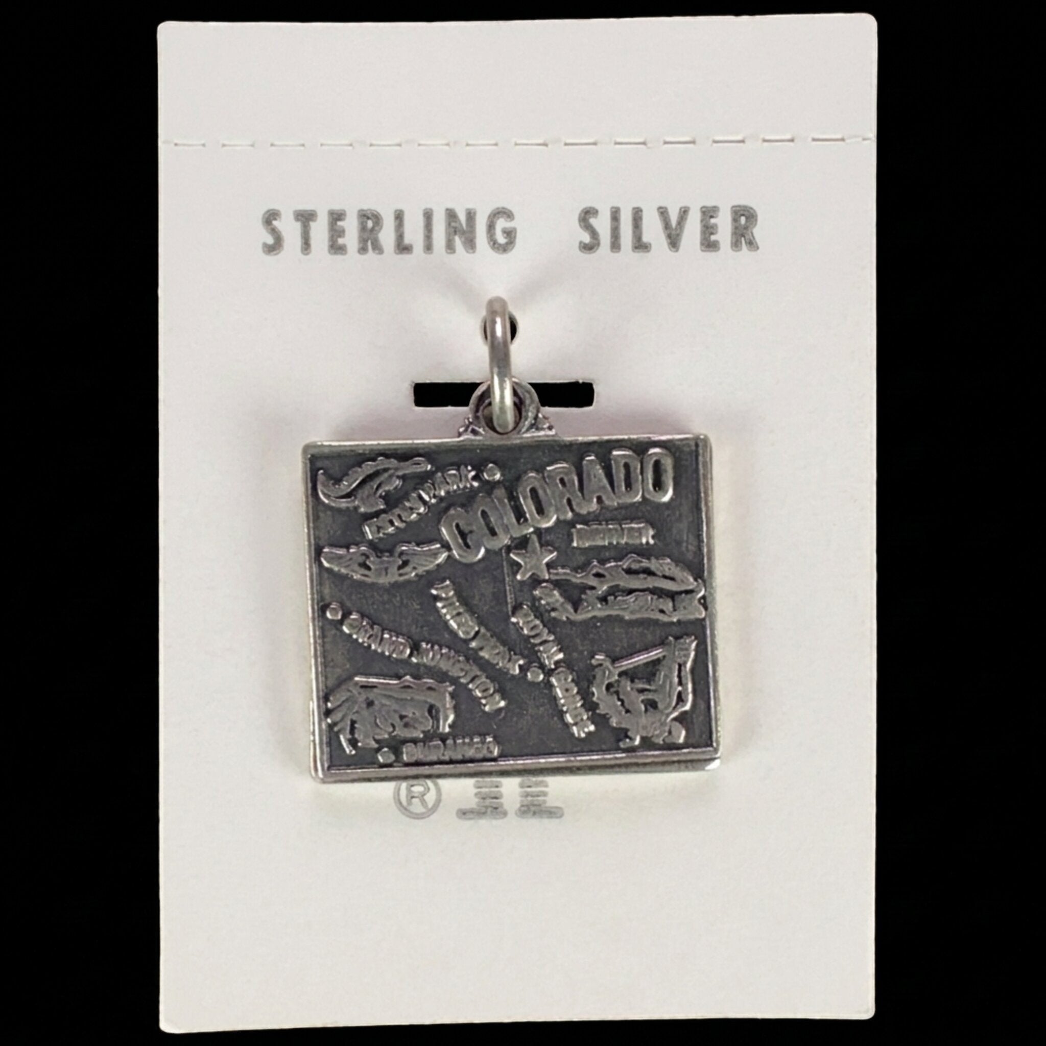 Vintage Maisel's sterling silver Colorado state map charm on its original trading post card