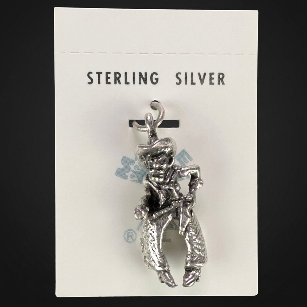 Vintage Maisel's sterling silver cowboy charm in woolly chaps on its original trading post card