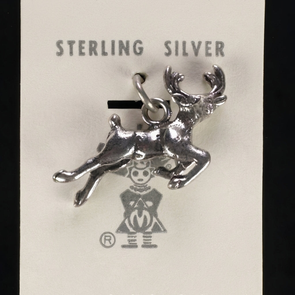 Vintage Maisel's sterling silver leaping elk charm on its original trading post card