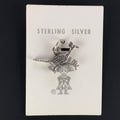 Vintage Maisel's small textured sterling silver roadrunner charm on its original trading post card