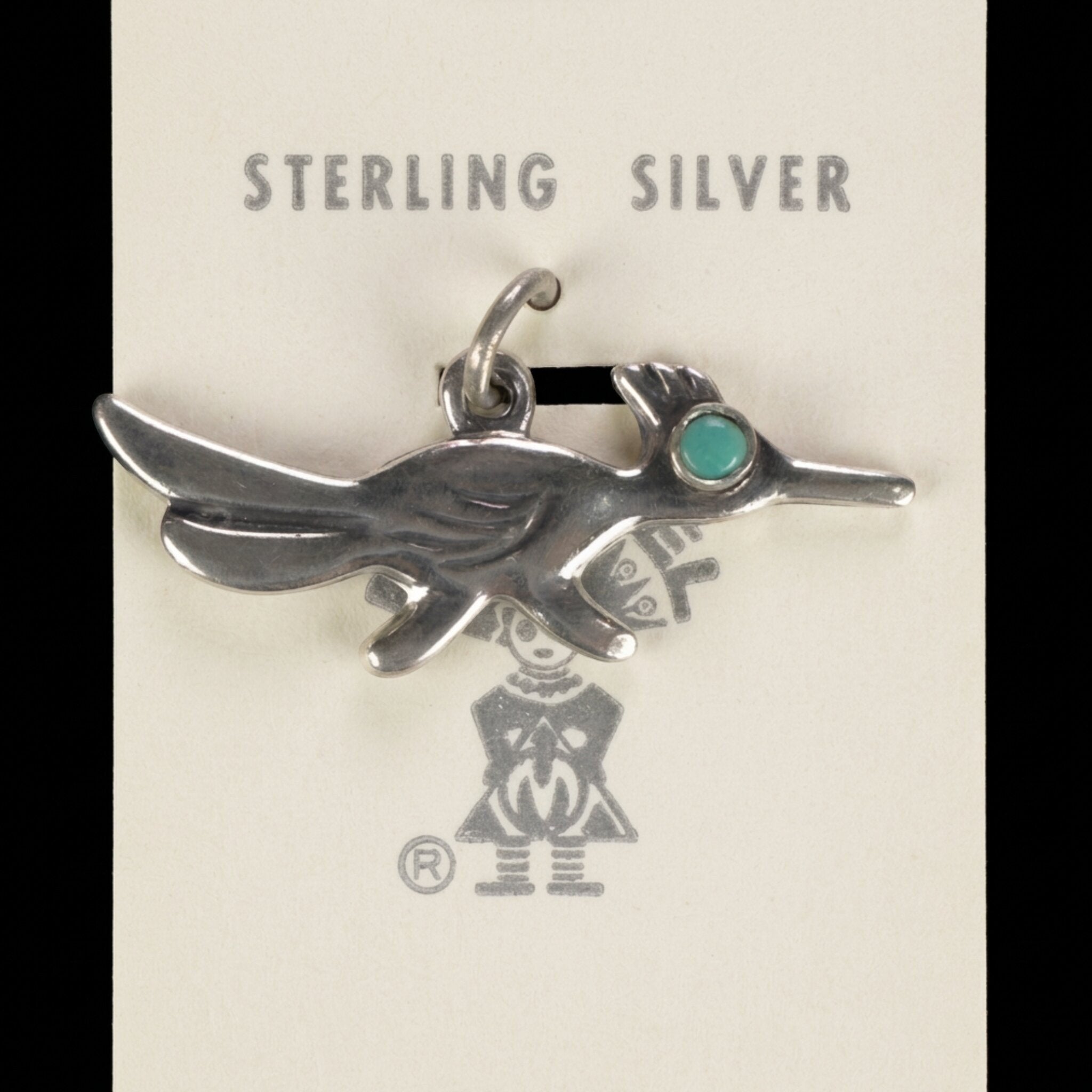 Vintage Maisel's sterling silver roadrunner charm with a turquoise eye on its original trading post card