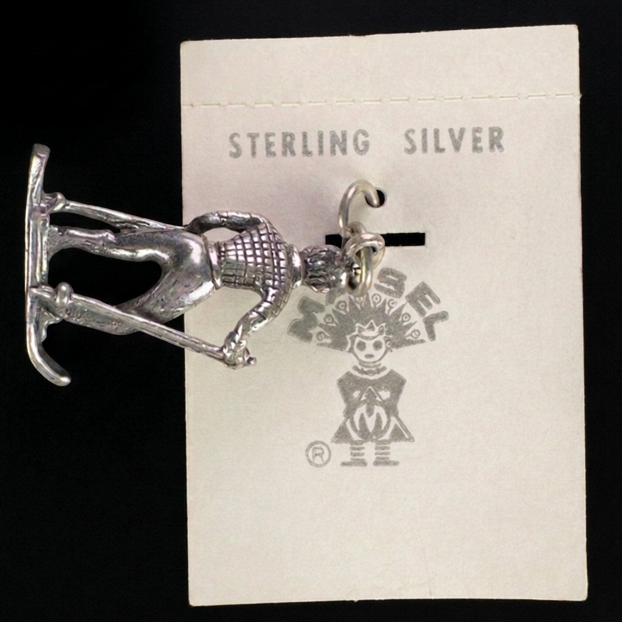 Reverse of the vintage Maisel's sterling silver skier charm showing the skis