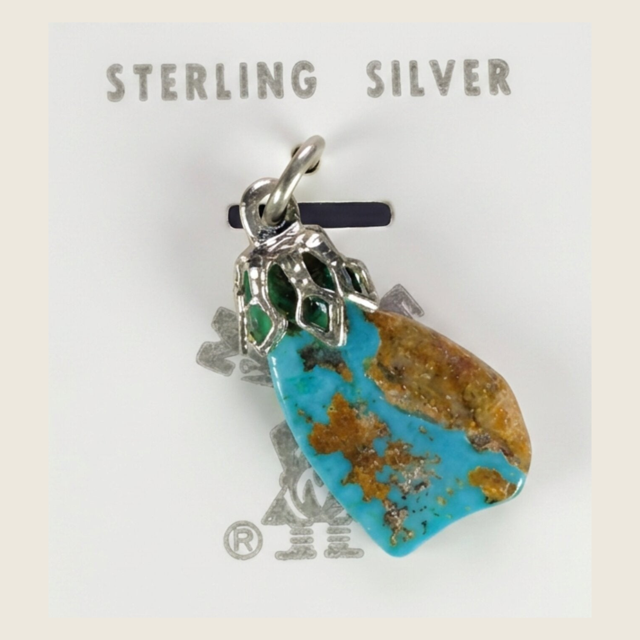Vintage Maisel's spiderweb turquoise nugget pendant in sterling silver, shown on a bone linen background