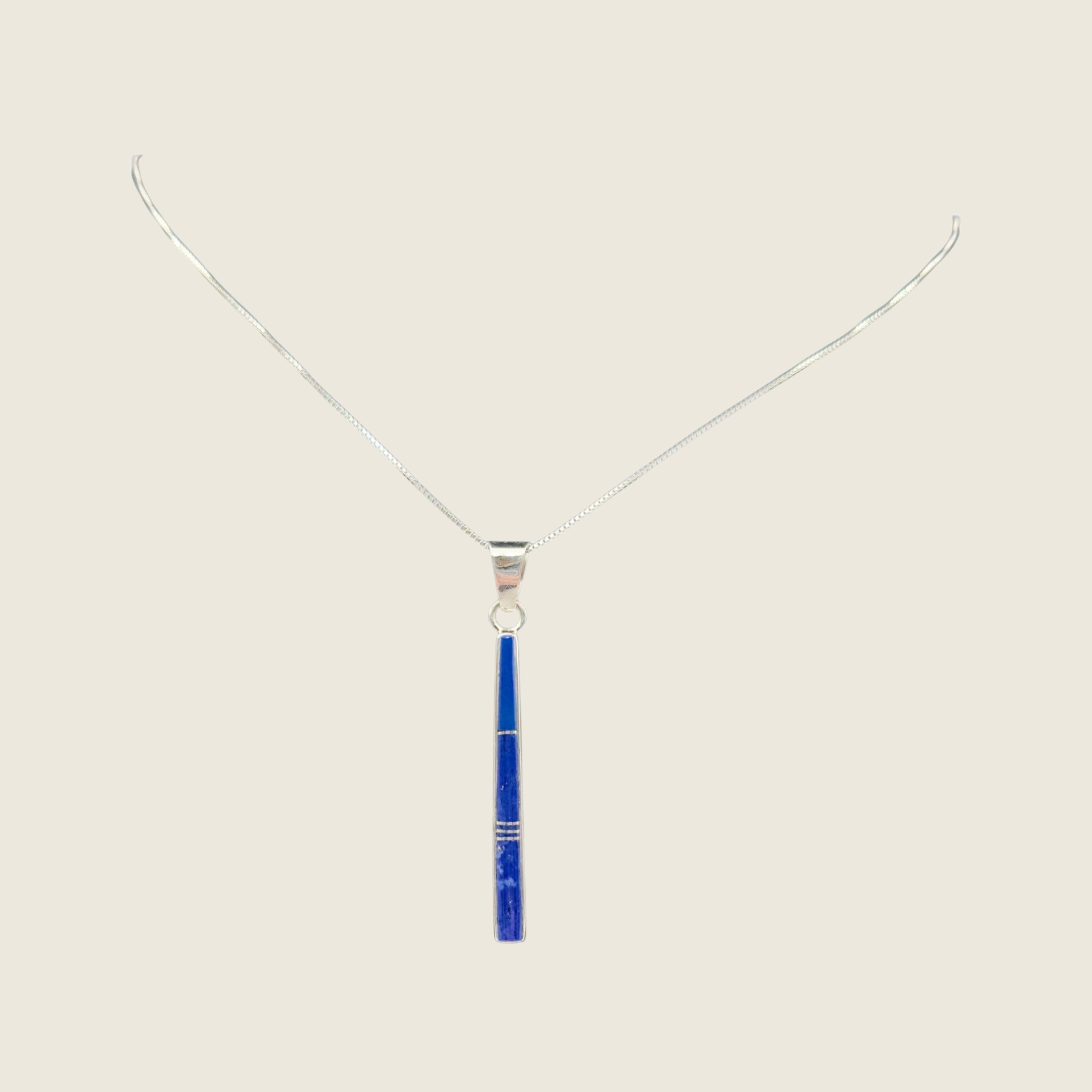 Lapis lazuli necklace in sterling silver by Rick Tolino, shown on a bone linen background