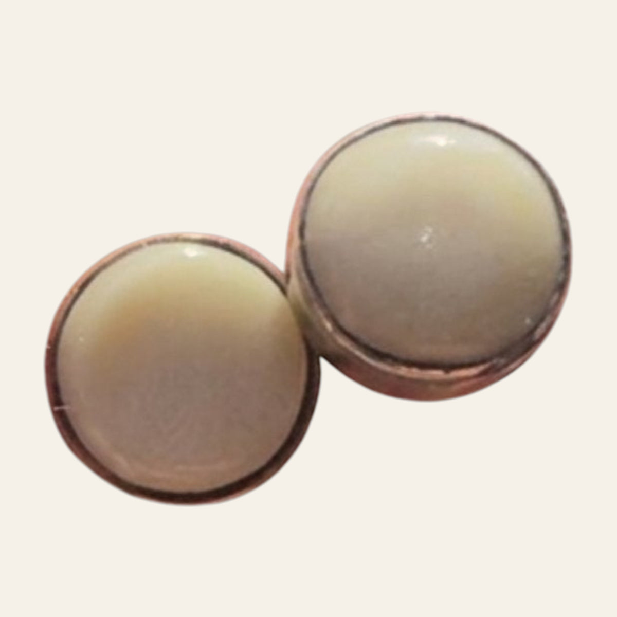 Mother of Pearl Round Stud Earrings in Sterling Silver, shown on a cream background