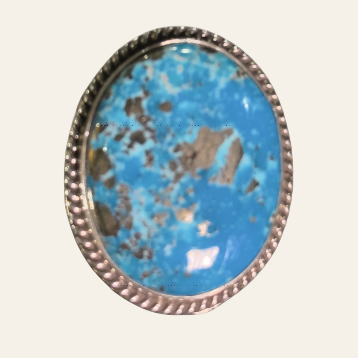 Nacozari Turquoise Statement Ring in Navajo Sterling Silver, by P. Yazzie, shown on a cream background