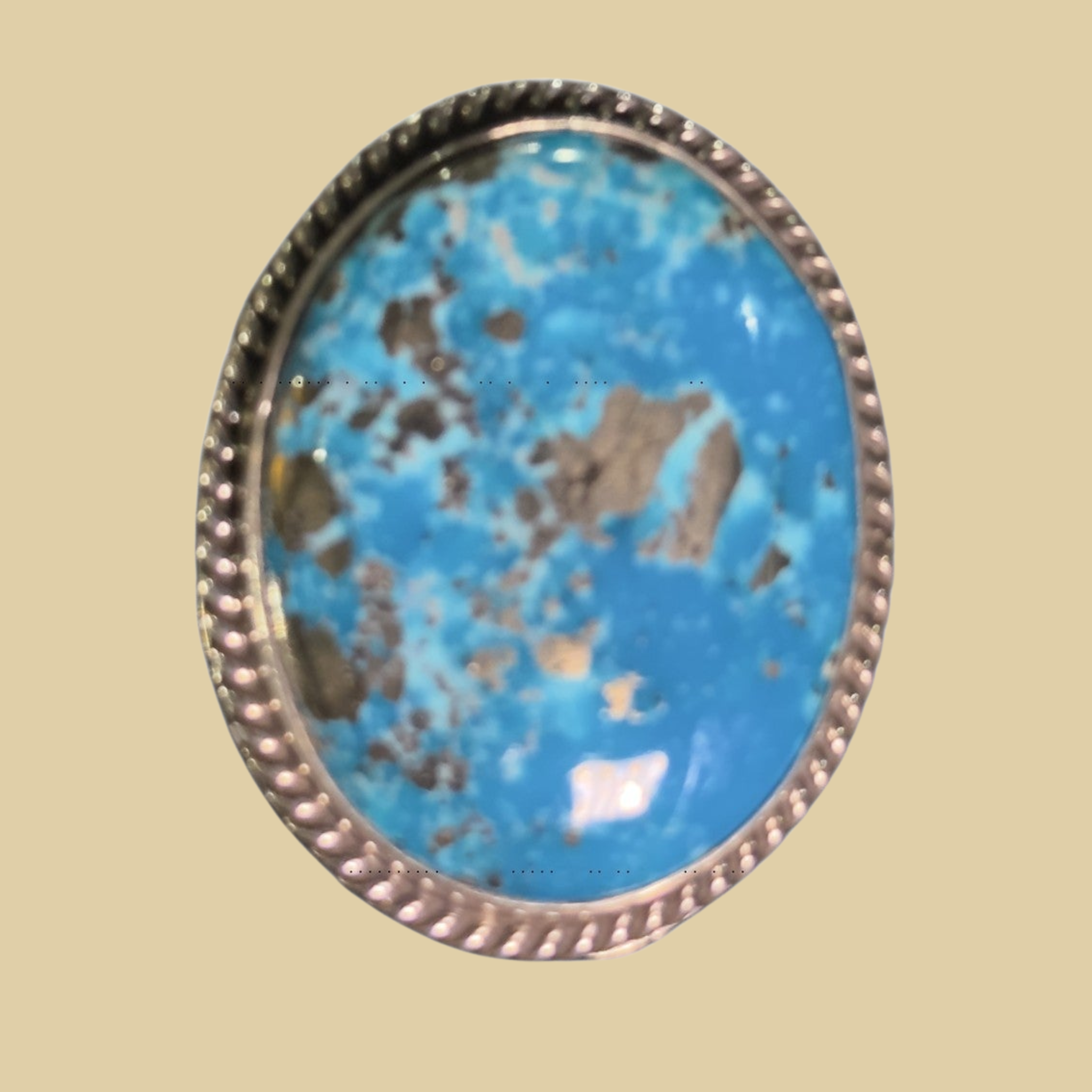 Nacozari Turquoise Statement Ring in Navajo Sterling Silver, by P. Yazzie, shown on a desert plaster background