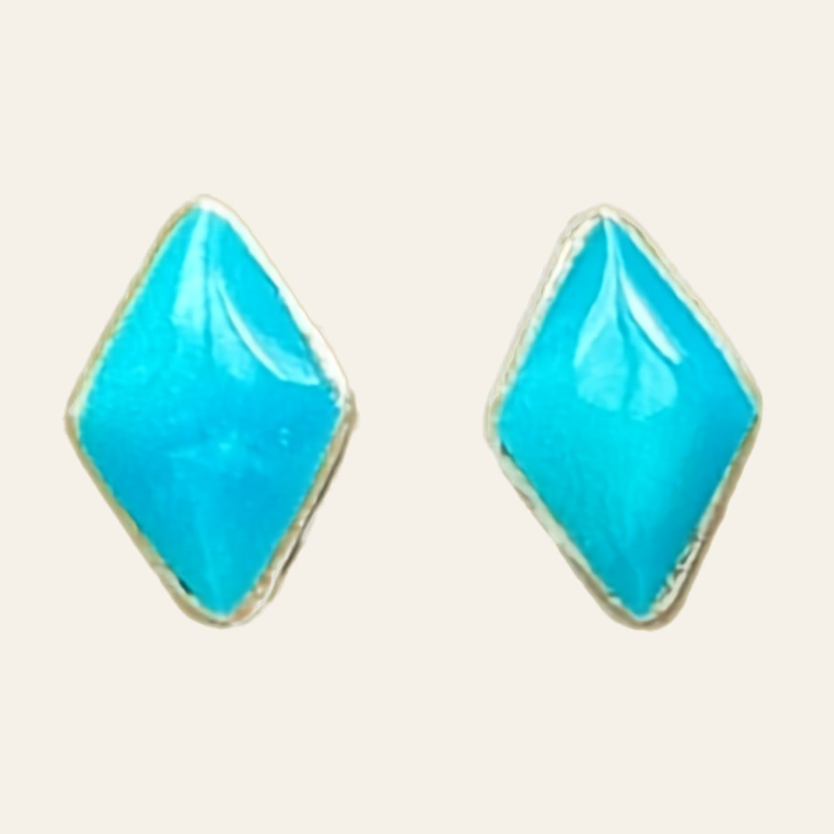 Natural Turquoise Kite Stud Earrings in Sterling Silver, shown on a cream background