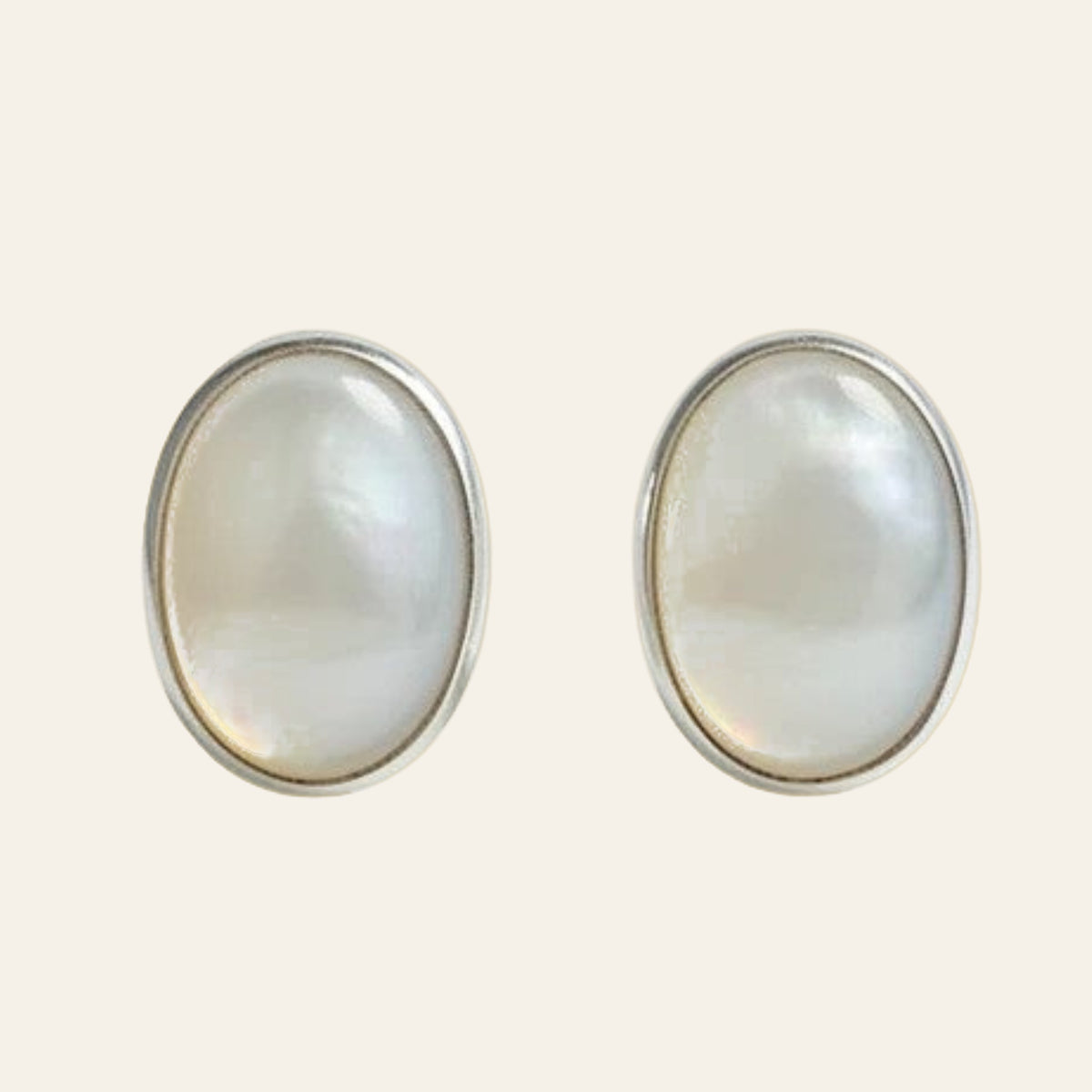 Opal Oval Stud Earrings in Sterling Silver, 7.5mm, shown on a cream background