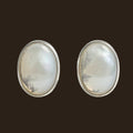 Opal Oval Stud Earrings in Sterling Silver, 7.5mm, shown on an espresso background