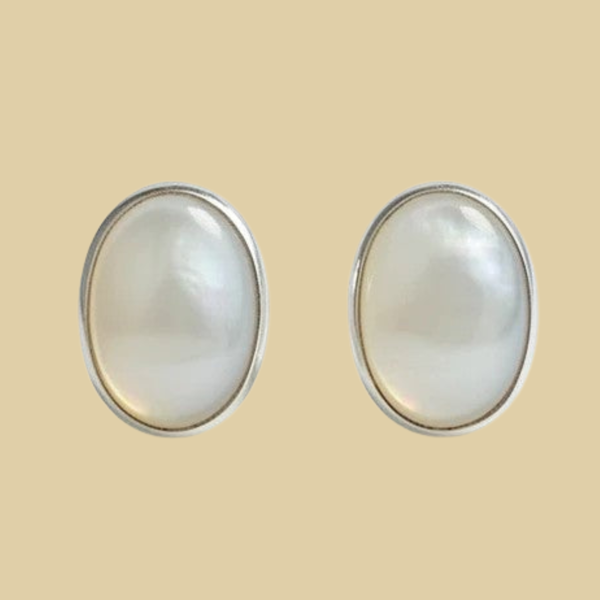 Opal Oval Stud Earrings in Sterling Silver, shown on a desert plaster background