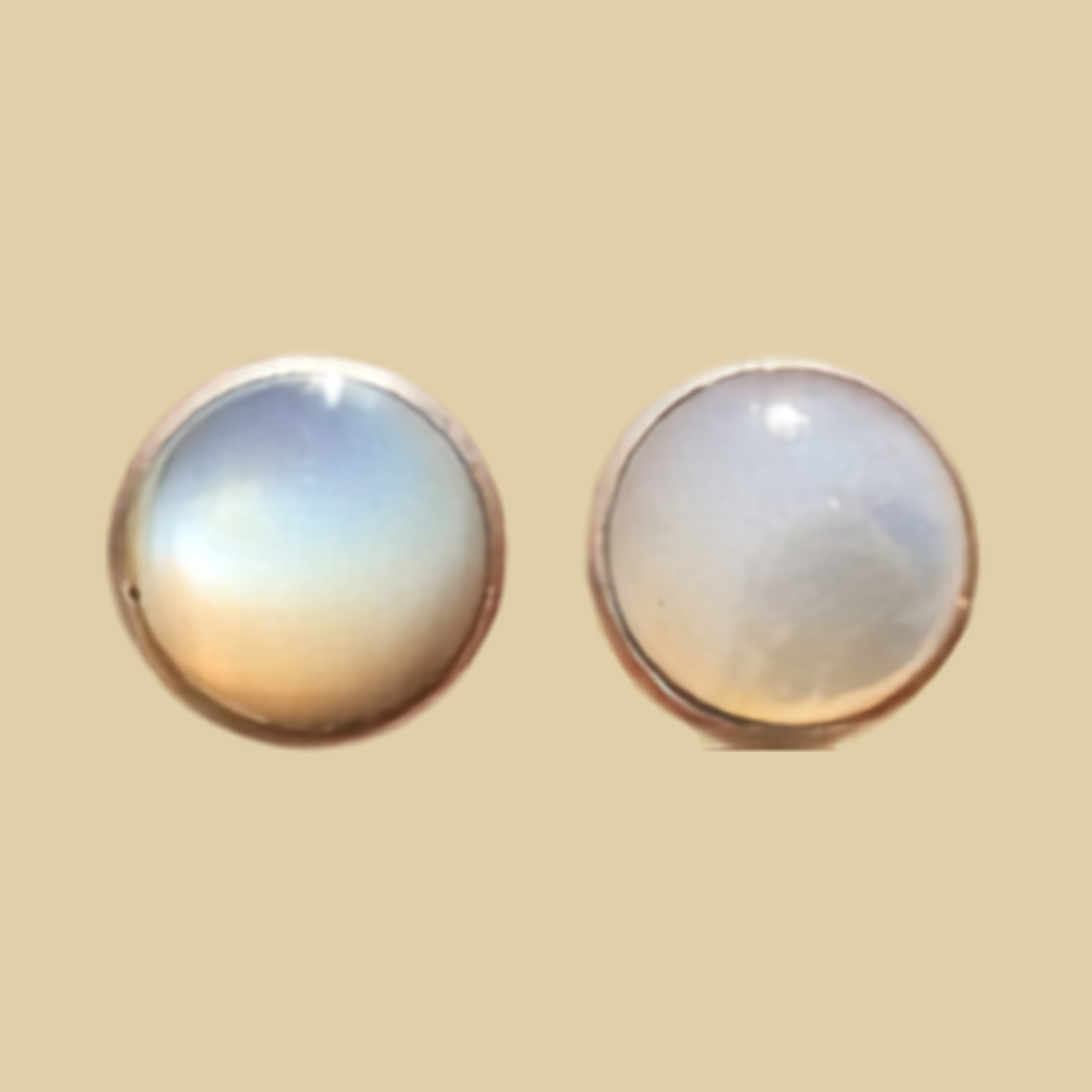 Opal Round Stud Earrings in Sterling Silver, shown on a desert plaster background
